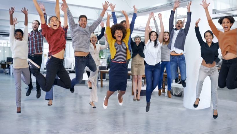 Motivated employees jumping after succeeding