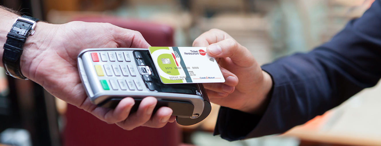 Person tapping Ticket Restaurant card on to card reader