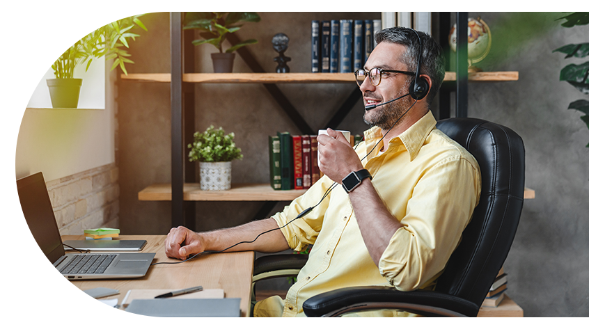 Call centre man at desk smiling