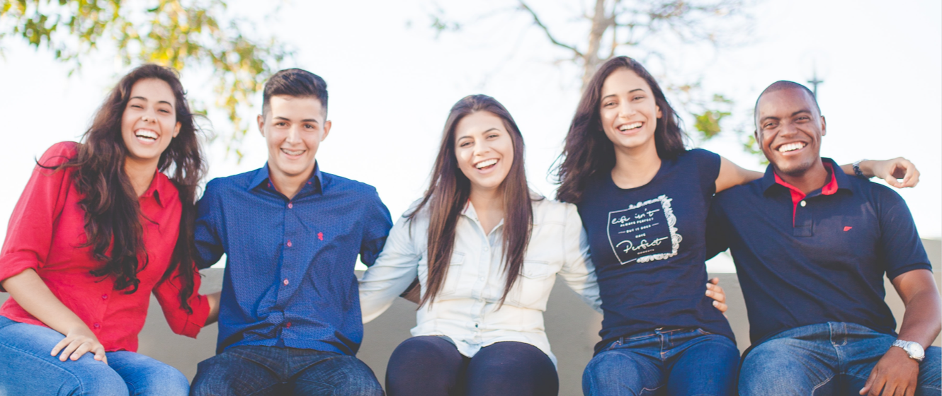 Group of people sitting down smiling